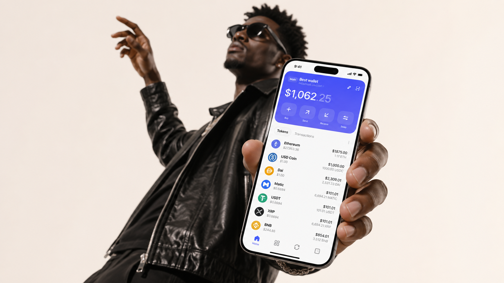 A person in a black leather jacket holds a phone displaying the Best Wallet portfolio screen