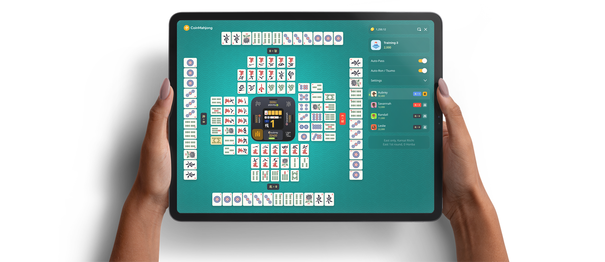 Hands holding a tablet showing the full CoinMahjong table view